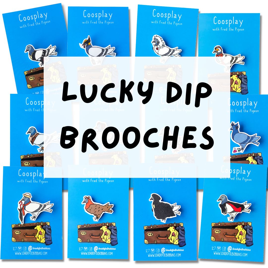 A photo of a selection of illustrated brooches showing a pigeon cosplaying as various pop culture icons, superheroes and sci-fi characters.