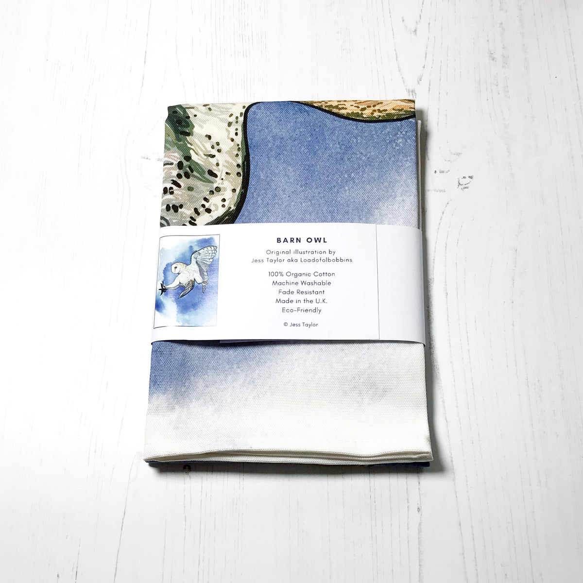 Text on a belly band around a folded tea towels they say barn owl. Original llustration by Jess Taylor aka Loadofolbobbins. 100% organic cotton, machine washable, fade resistant,made in the UK, Eco friendly. Copyright Jess Taylor.