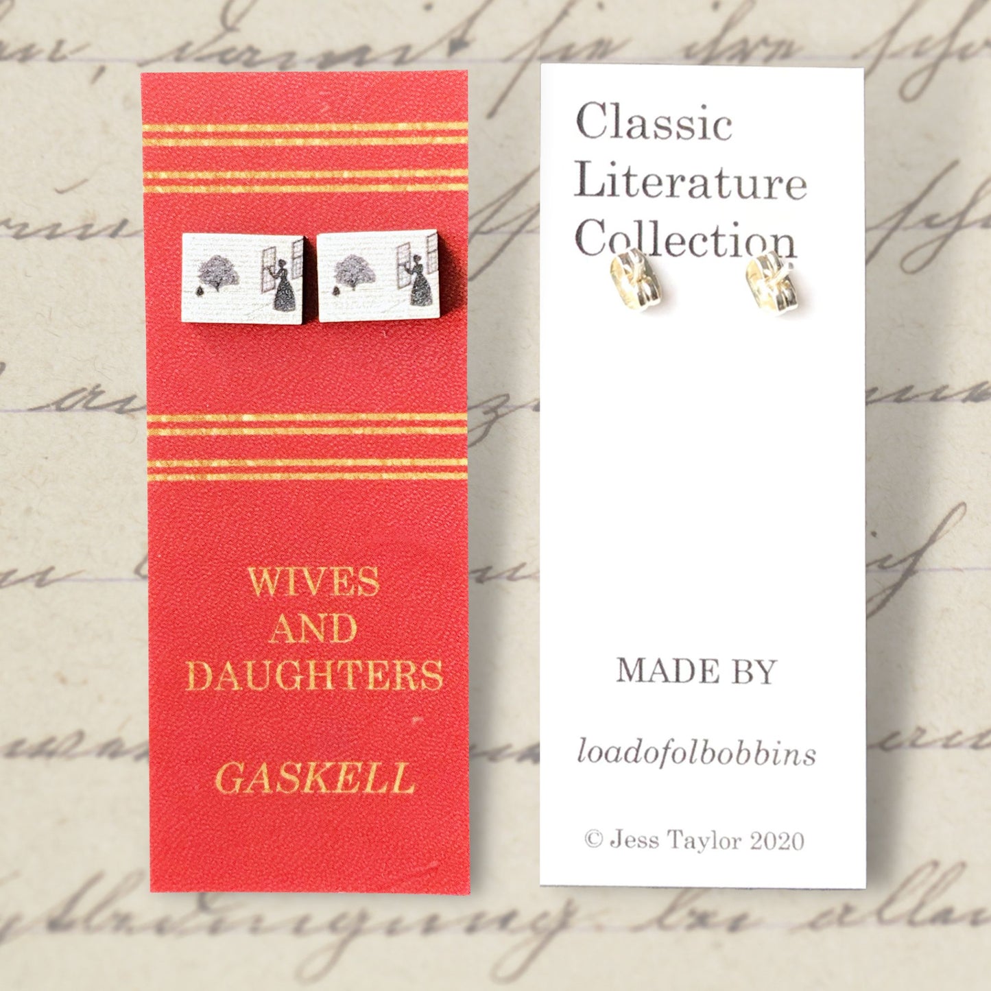 A laser cut wooden stud earrings by loadofolbobbins showing a silhouette scene inspired by the novel Wives and Daughters by Elizabeth Gaskell. The scene shows Molly looking out of the window at Roger standing under a large tree. The scene is printed against original text from the novel. The necklace is mounted on a red backing card with gold lettering detail and made to look like the front of a book.